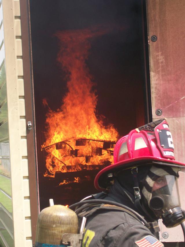 The fire is allowed to grow and is seen here starting to roll across the ceiling